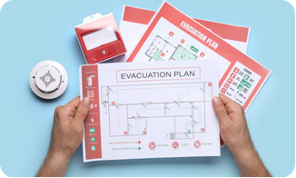 Hands holding a printed evacuation plan floor map